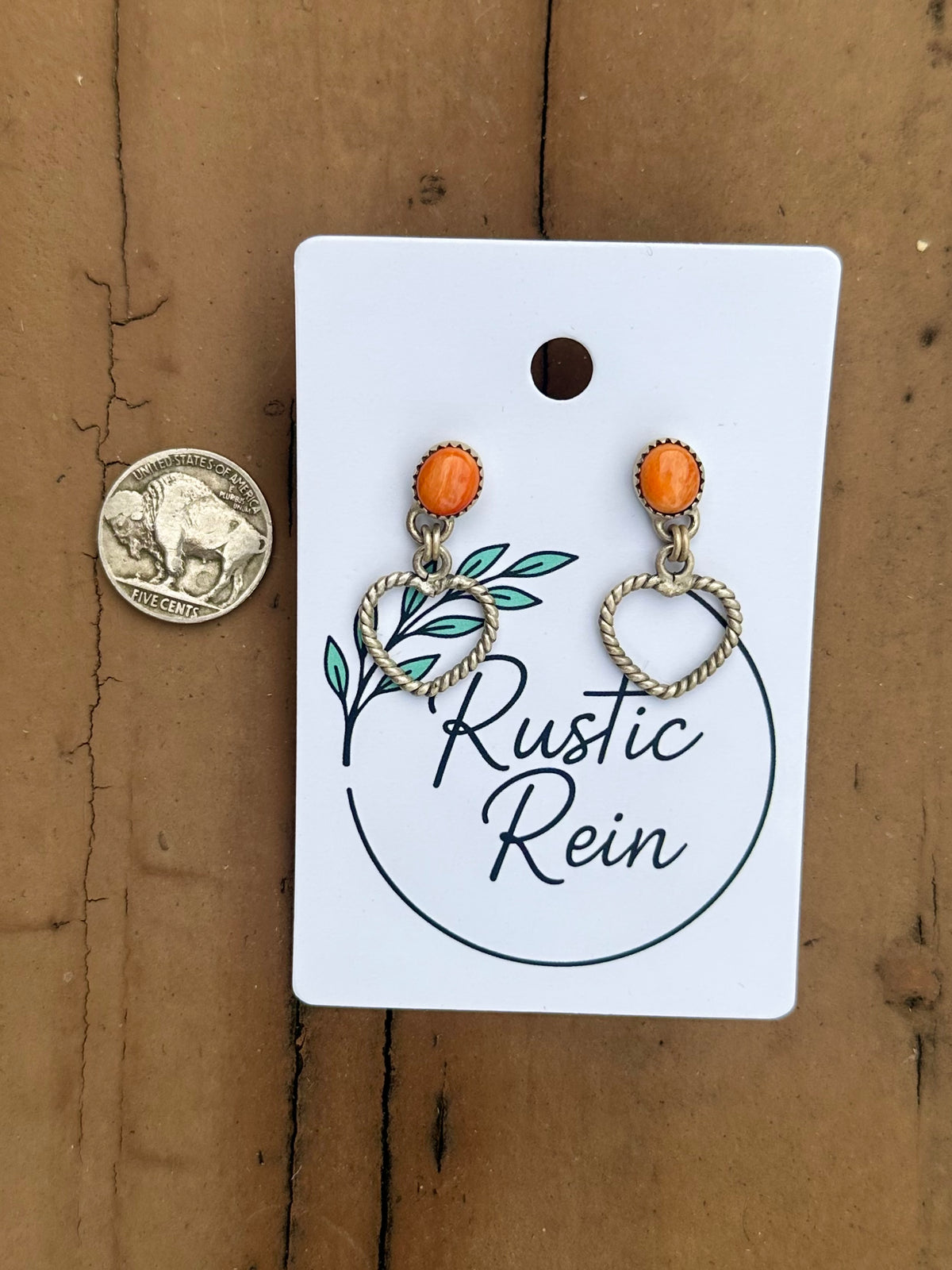 Orange spiny heart earrings
