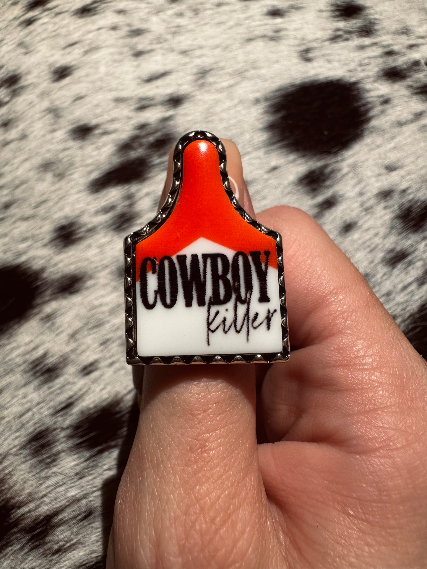 Adjustable cowboy killer cow tag ring