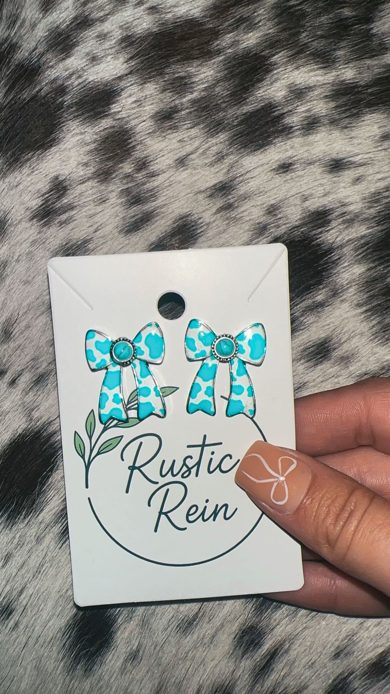 Blue cowprint bow earrings